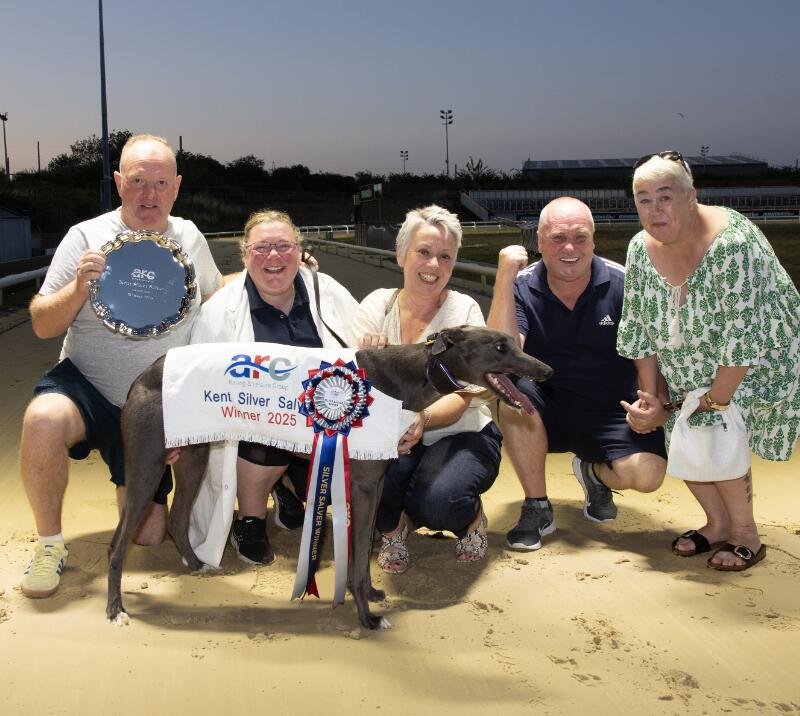 A group pose with the winning greyhound at Central Park Greyhounds
