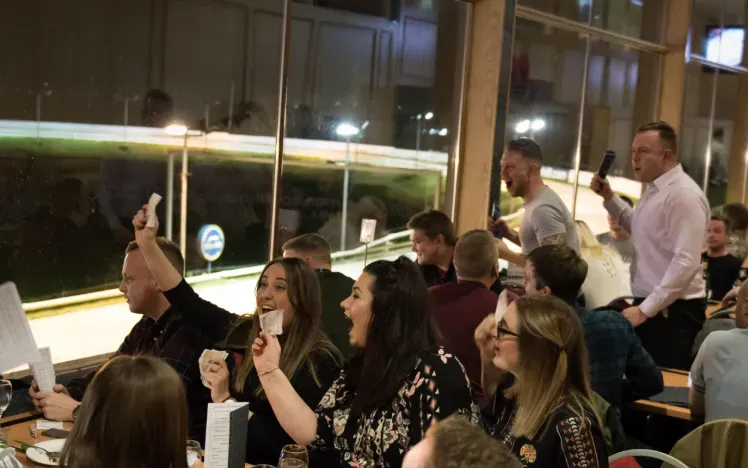 Hospitality guests at Central Park cheer the race