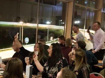 Hospitality guests at Central Park cheer the race